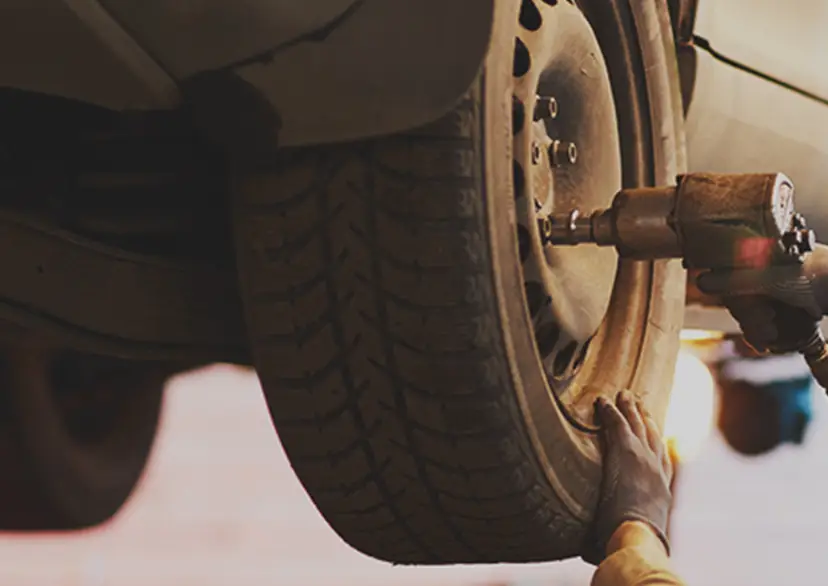 repairman-fixing-car-wheel