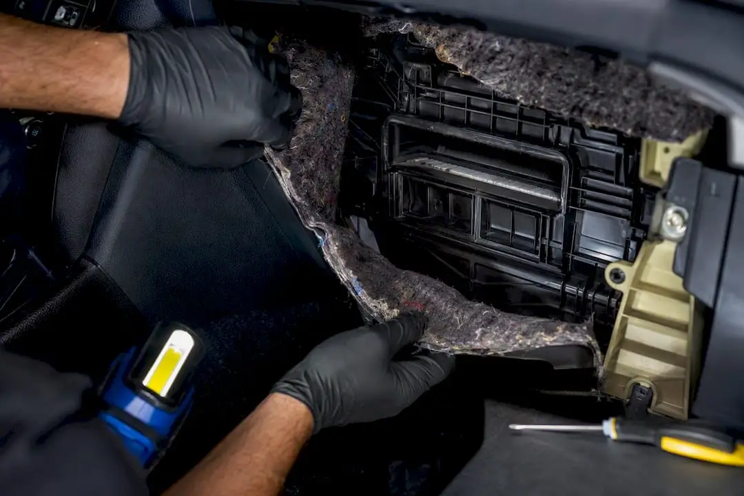Mechanic inspecting contaminated HVAC housing