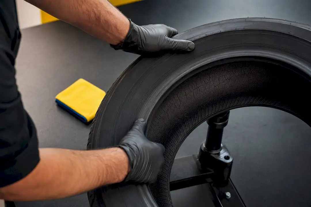 Technician examining tire cracks and bead